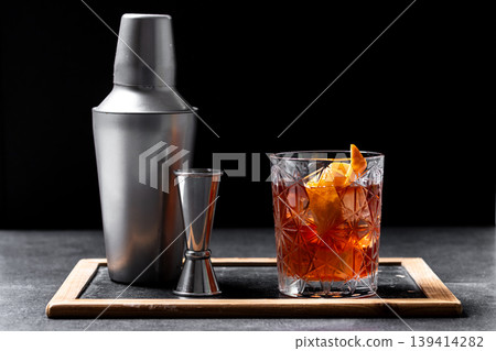 Old Fashioned Cocktail with Orange Peel on black background Old Fashioned Cocktail with Orange Peel on black background 139414282