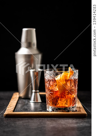 Old Fashioned Cocktail with Orange Peel on black background Old Fashioned Cocktail with Orange Peel on black background 139414283