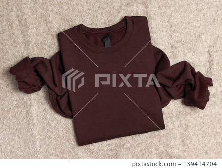 Blank dark brown unisex sweatshirt mockup, folded apparel template with copy space on front Blank dark brown unisex sweatshirt mockup, folded apparel template with copy space on front 139414704