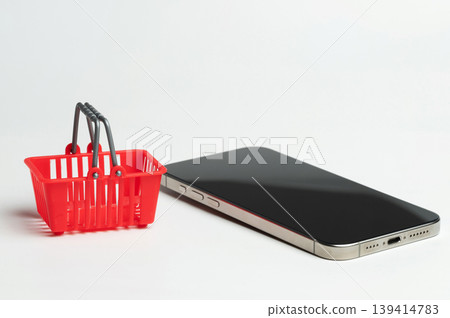 Red shopping basket with smartphone Red shopping basket with smartphone 139414783