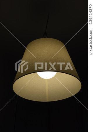 Hanging lamp with warm light on dark background Hanging lamp with warm light on dark background 139414870