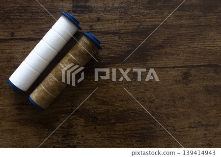 New and used water filter cartridges on wooden background with copy space 139414943