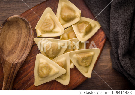 Triangular Ravioli Pasta On Wooden Board With Spoon Rustic Uncooked Italian Dough 139415488