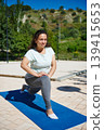 Woman Doing Lunge Exercise Outdoors on Yoga Mat - Outdoor Fitness Workout 139415653