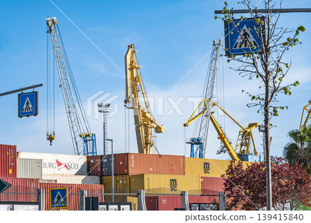 Port crane and shipping containers. Industrial and logistics concept. Maritime, shipping industry Port crane and shipping containers. Industrial and logistics concept. Maritime, shipping industry 139415840