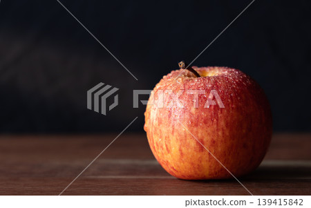 Close-up image of a red Apple with water droplets on dark background Close-up image of a red Apple with water droplets on dark background 139415842