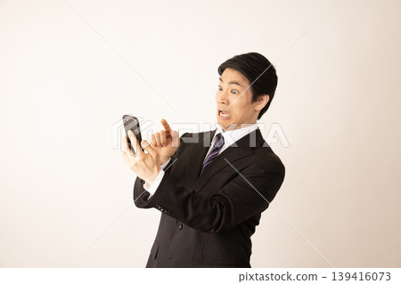 A man surprised at his smartphone screen 139416073