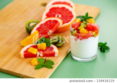 vibrant healthy snack with yogurt fruit mix and mint leaves composition vibrant healthy snack with yogurt fruit mix and mint leaves composition 139416119