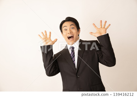 A man surprised raising his hands A man surprised raising his hands 139416212