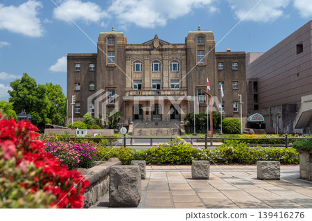 A spring scene capturing the exterior of Kagoshima City Central Community Center through a flowerbed (fresh greenery, blue sky, Kagoshima City). A spring scene capturing the exterior of Kagoshima City Central Community Center through a flowerbed (fresh greenery, blue sky, Kagoshima City). 139416276