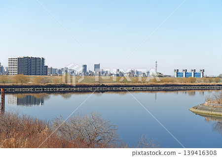 城市天際線倒映在水面上，湛藍的天空和芝川水閘構成了一幅寧靜的河畔景象。 139416308