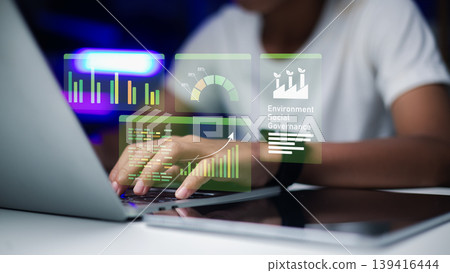 Environmental social and governance holographic interface for corporate report,Business professional analyzing ESG sustainability data on laptop,Workspace with ESG dashboard for investment strategy. 139416444