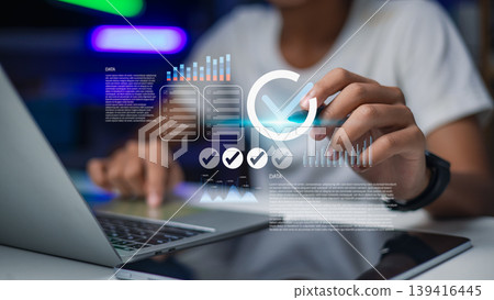 Business professional verifying data compliance with digital checkmark interface 139416445