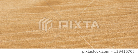 Perfectly parallel ridges on a sandy surface create a rigid mathematical rhythm. This structured landscape offers a clean architectural background for premium design Perfectly parallel ridges on a sandy surface create a rigid mathematical rhythm. This structured landscape offers a clean architectural background for premium design 139416705