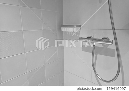 Modern Bathroom Interior with Wall-Mounted Shower, Soap Holder, and Minimalist Design Modern Bathroom Interior with Wall-Mounted Shower, Soap Holder, and Minimalist Design 139416997