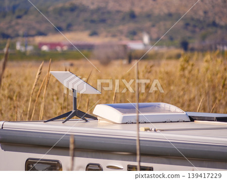 Caravan roof with equipment Starlink terminal satellite dish, sunroof and awning on side Caravan roof with equipment Starlink terminal satellite dish, sunroof and awning on side 139417229