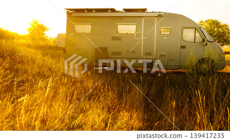 Sunrise over caravan camping on nature. Summer trip. Sunrise over caravan camping on nature. Summer trip. 139417235
