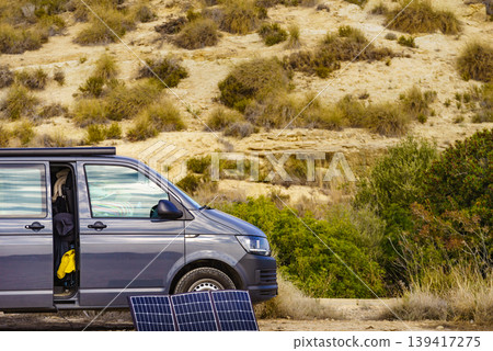 Portable solar photovoltaic panel, charging battery at camper van vehicle. Portable solar photovoltaic panel, charging battery at camper van vehicle. 139417275
