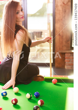 Young woman posing having fun with billiard. Young woman posing having fun with billiard. 139417409