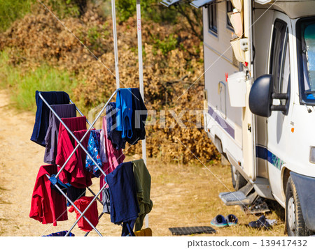 Clothes hanging to dry outdoors by camping car. Caravan vacation. Clothes hanging to dry outdoors by camping car. Caravan vacation. 139417432