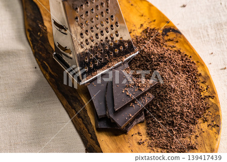 Grater and grated chocolate closeup Grater and grated chocolate closeup 139417439