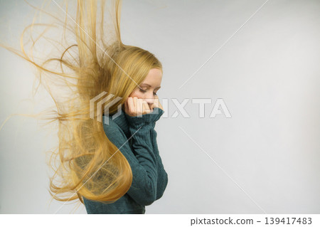 Sad girl with blowing hair 139417483