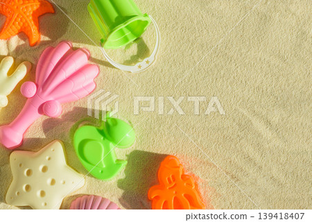 Colorful Beach Toys and Molds on Sand. Summer Fun and Outdoor Play FlatLay Colorful Beach Toys and Molds on Sand. Summer Fun and Outdoor Play FlatLay 139418407