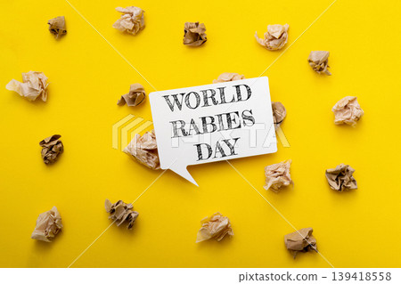 World Rabies Day awareness concept with speech bubble on vibrant yellow background surrounded by crumpled paper, emphasizing the importance of health education and disease prevention 139418558