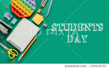 Colorful stationery and supplies arranged on green background for Students Day celebration Colorful stationery and supplies arranged on green background for Students Day celebration 139418735