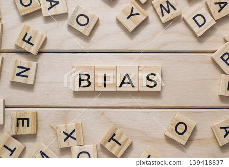 Wooden letter tiles spelling bias on a light wooden surface with scattered letters around Wooden letter tiles spelling bias on a light wooden surface with scattered letters around 139418837