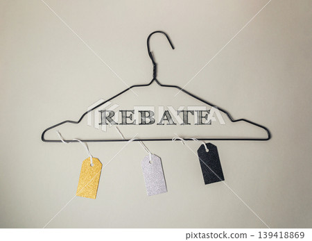 Clothes hanger with tags on it that say Rebate Clothes hanger with tags on it that say Rebate 139418869