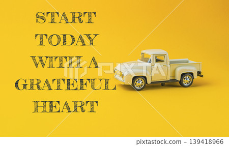 Vintage toy truck on bright yellow background with motivational text for positive mindset Vintage toy truck on bright yellow background with motivational text for positive mindset 139418966