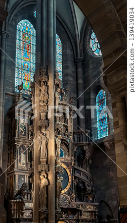 Intricate architectural details of a historic church interior featuring ornate sculptures and colorful stained glass windows illuminating the space Intricate architectural details of a historic church interior featuring ornate sculptures and colorful stained glass windows illuminating the space 139419034