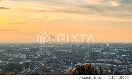Urban landscape at sunset showcasing industrial skyline with smokestacks, residential areas, and distant hills, capturing the essence of city life and nature's beauty Urban landscape at sunset showcasing industrial skyline with smokestacks, residential areas, and distant hills, capturing the essence of city life and nature's beauty 139419093