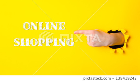 Hand pointing to the word online shopping on a yellow background Hand pointing to the word online shopping on a yellow background 139419242