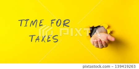Hand emerging from yellow background with text indicating tax season and financial awareness Hand emerging from yellow background with text indicating tax season and financial awareness 139419263