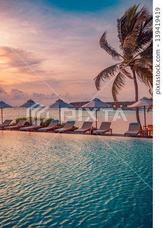 Tranquil sunset poolside summer resort with sunbeds and umbrellas on a carefree vacation featuring a peaceful outdoor swimming pool and relaxing beach vibes Tranquil sunset poolside summer resort with sunbeds and umbrellas on a carefree vacation featuring a peaceful outdoor swimming pool and relaxing beach vibes 139419419