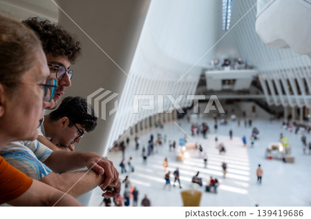 New york, usa august 17,2024. Family observing the modern architecture and busy commuters inside the santiago calatrava designed oculus at the world trade center, new york New york, usa august 17,2024. Family observing the modern architecture and busy commuters inside the santiago calatrava designed oculus at the world trade center, new york 139419686