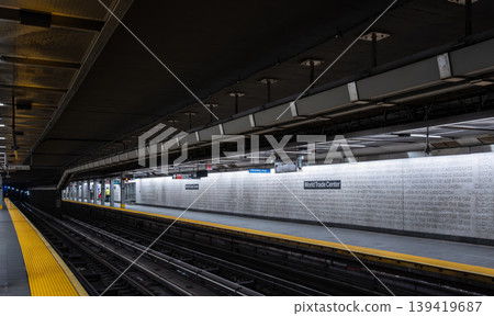 New york, usa august 17,2024. World trade center path station platform in manhattan, empty tracks, textured concrete wall with signage and moody underground lighting New york, usa august 17,2024. World trade center path station platform in manhattan, empty tracks, textured concrete wall with signage and moody underground lighting 139419687