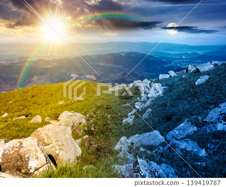 day meet night. carpathian mountain summer solstice landscape. alpine meadow with huge stones among the grass on top of the hillside near the peak of mountain range. epic sky view. harmony concept 139419787