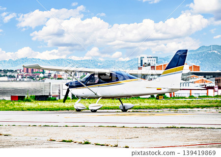 A single-engine ultralight aircraft waiting to take off at the airfield. 139419869