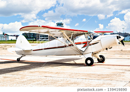 A single-engine ultralight aircraft waiting to take off at the airfield. 139419890