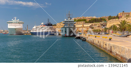 Cruise and naval ships in harbor of Valletta Malta with waterfront and fortifications Cruise and naval ships in harbor of Valletta Malta with waterfront and fortifications 139421145