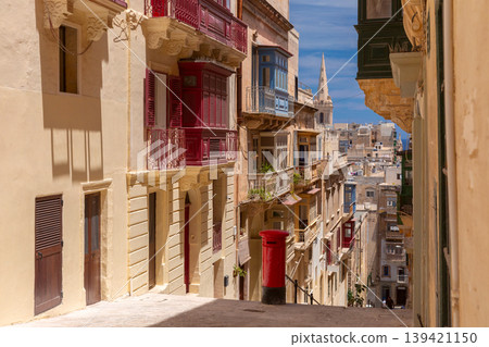 Narrow historic street with traditional balconies in Valletta Malta 139421150