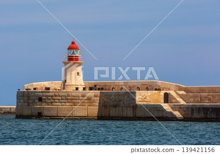 Historic lighthouse on breakwater in Grand Harbour of Valletta Malta Historic lighthouse on breakwater in Grand Harbour of Valletta Malta 139421156