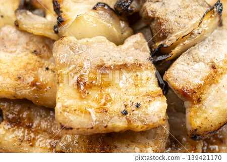 Close-up of salt-grilled pork belly skewers (yakiton) cooked over charcoal. Close-up of salt-grilled pork belly skewers (yakiton) cooked over charcoal. 139421170