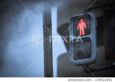 A pedestrian traffic light (red light) reflected in a puddle. A pedestrian traffic light (red light) reflected in a puddle. 139422091