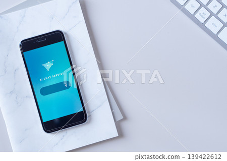 An AI (artificial intelligence) chat screen displayed on a smartphone placed on a desk. Original image. An AI (artificial intelligence) chat screen displayed on a smartphone placed on a desk. Original image. 139422612