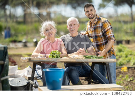 Happy family of farmers sits at table and discusses current affairs 139422793