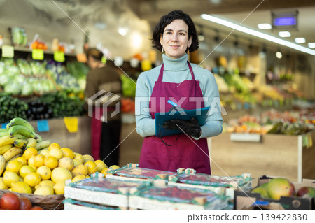 Woman seller take inventory with list in vegetable shop 139422830